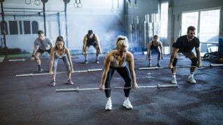 Group of people performing Romanian deadlift