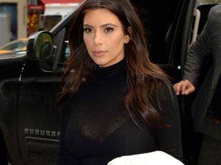 Kim Kardashian wears monochrome trend, see-through top.