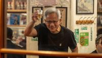 Jensen Huang toasting the camera person with a beer.
