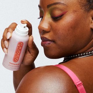 A person spraying the Topicals Faded Mist on their shoulder for Black-owned beauty and skincare brands.