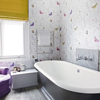 bathroom with butterfly designed wall bathtub and window