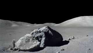 Scientist-astronaut Harrison H. Schmitt photographed standing next to a huge, split lunar boulder during the third Apollo 17 extravehicular activity (EVA) at the Taurus-Littrow landing site.
