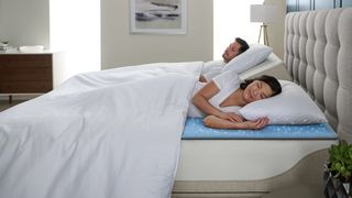 Woman and man sleeping in a Sleep Number smart bed.