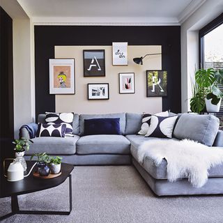 open plan living room with corner sofa and wall art