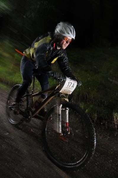 A rider completes the night time trial stage