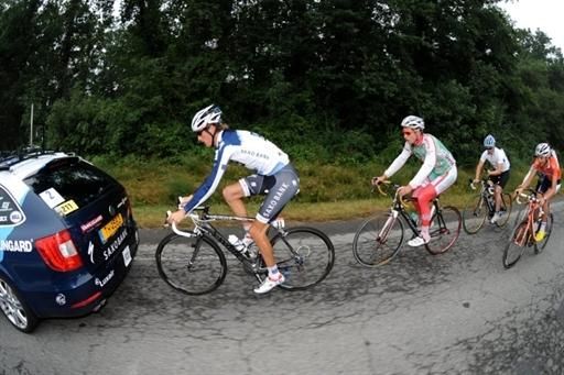 Andy Schleck paces behind the Saxo Bank car, being chased by fans.