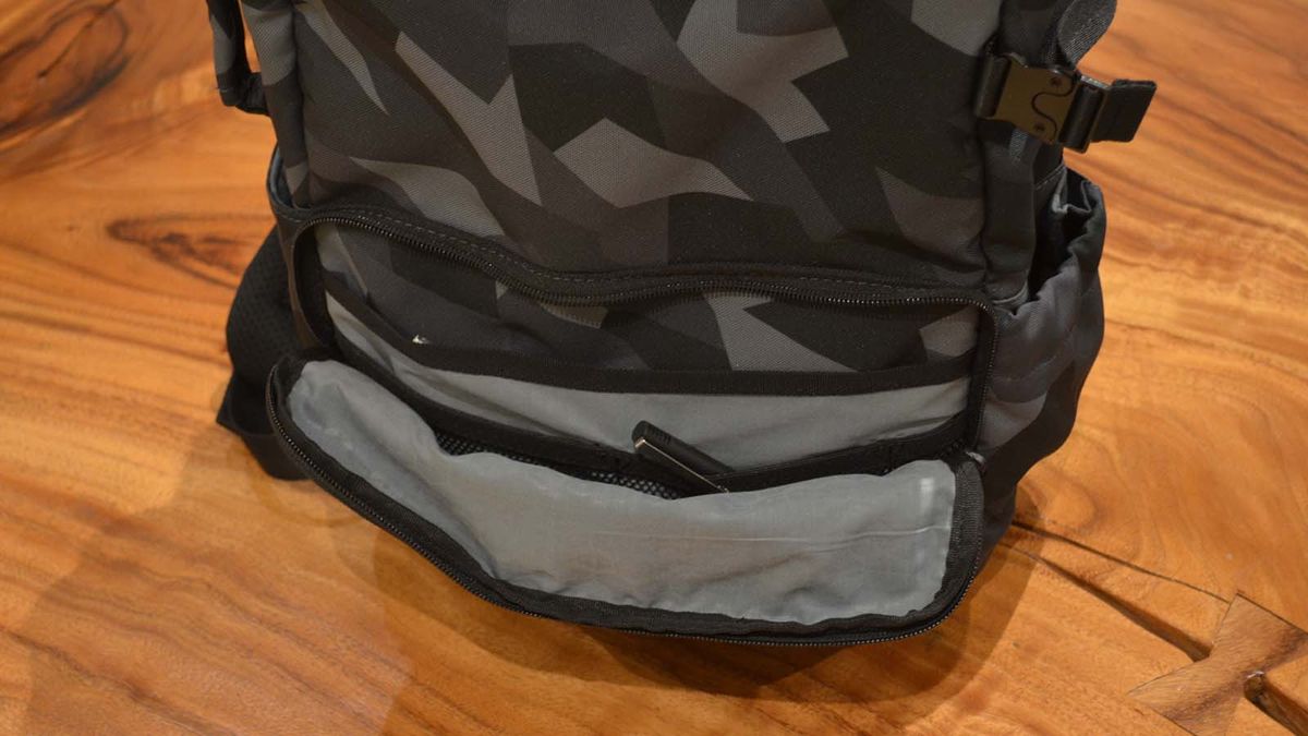 A Hex Technical Backpack on a wood grain table