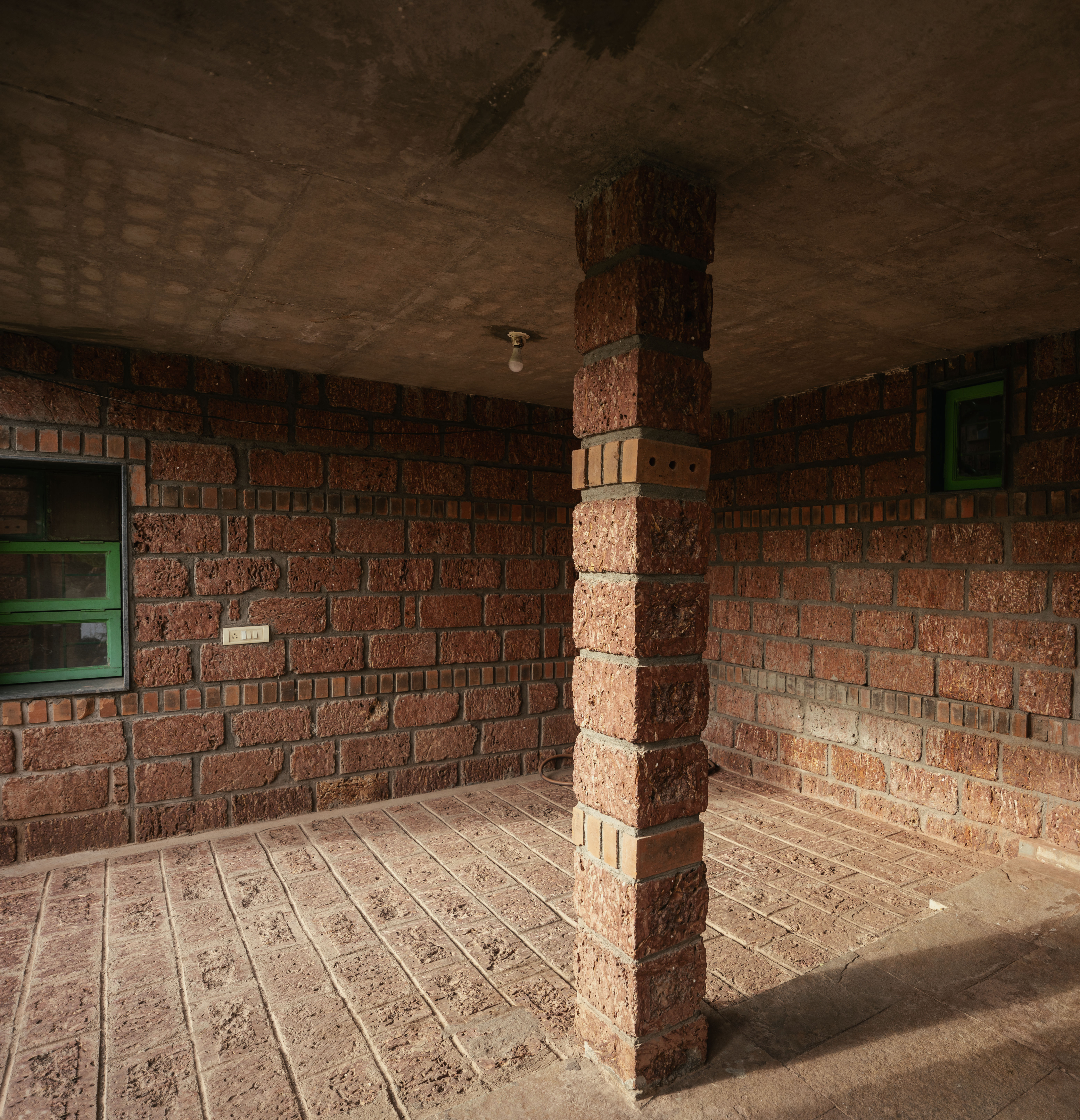 Kanade brothers house in India, brick structure in green surrounds