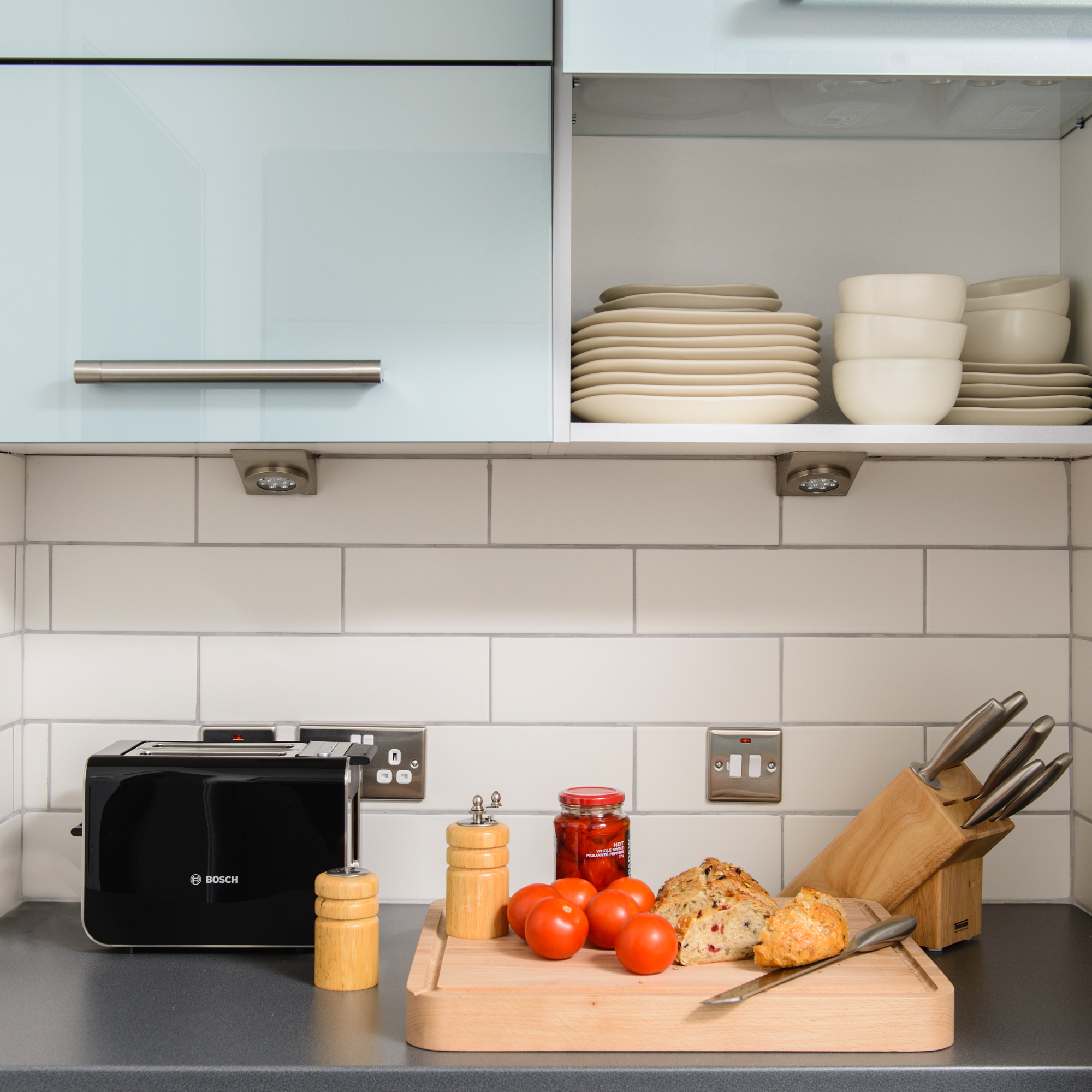 kitchen worktop with breadboard and knife block with knives