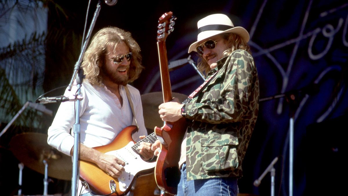 The Eagles&#039; Don Felder (left) and Joe Walsh exchange licks onstage in 1977