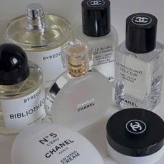 A selection of perfumes and beauty products on a white table