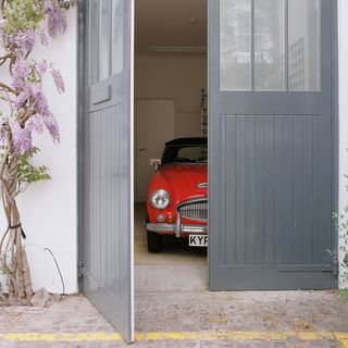 parking space with grey door and parked car