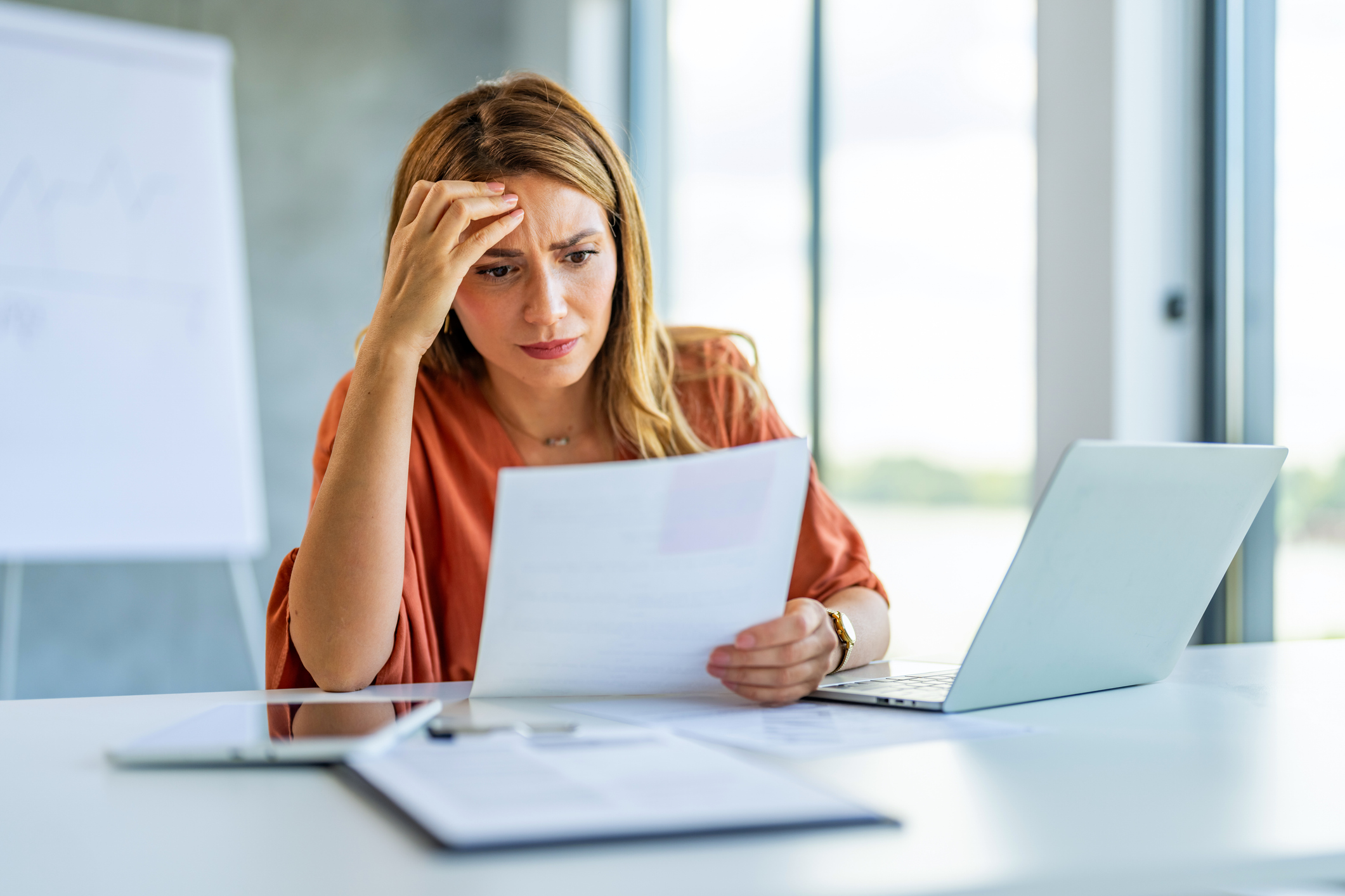 Woman looking concerned about personal finances.