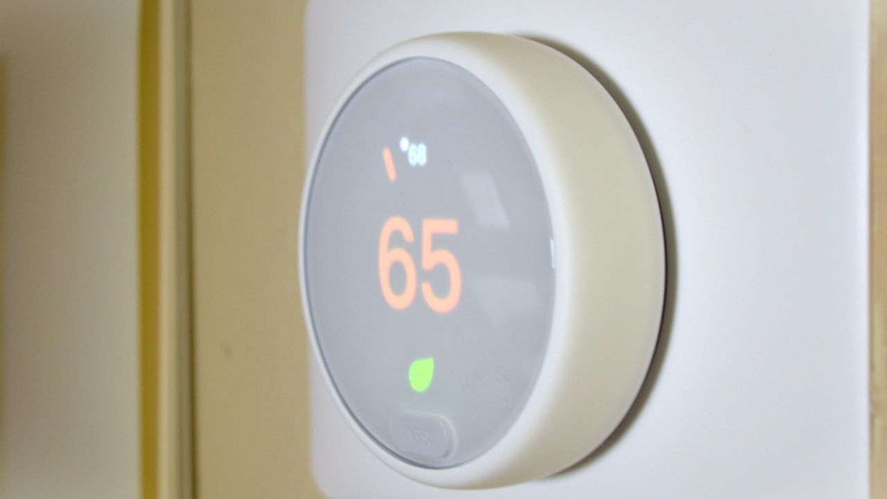 Nest Thermostat E smart thermostat (which is number five in our guide, mounted on wall, showing the current ambient temperature in Eco Mode