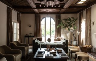 Wooden ceilings, fluffy green armchairs, black wooden coffee table