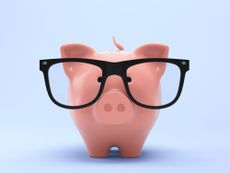 piggybank wearing black oversized glasses against a pale blue background