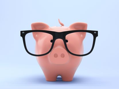 piggybank wearing black oversized glasses against a pale blue background