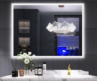 rectangular backlit mirror on black fluted tiled wall with grey and white marble vanity unit below and modern glass pendant light in mirror reflection