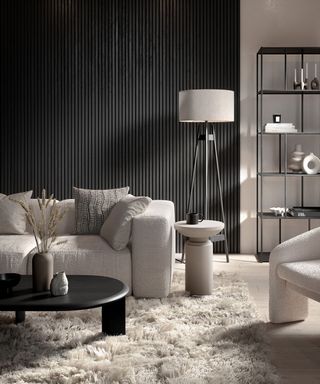 Monochrome living room of black wood panel walls and cream sofa