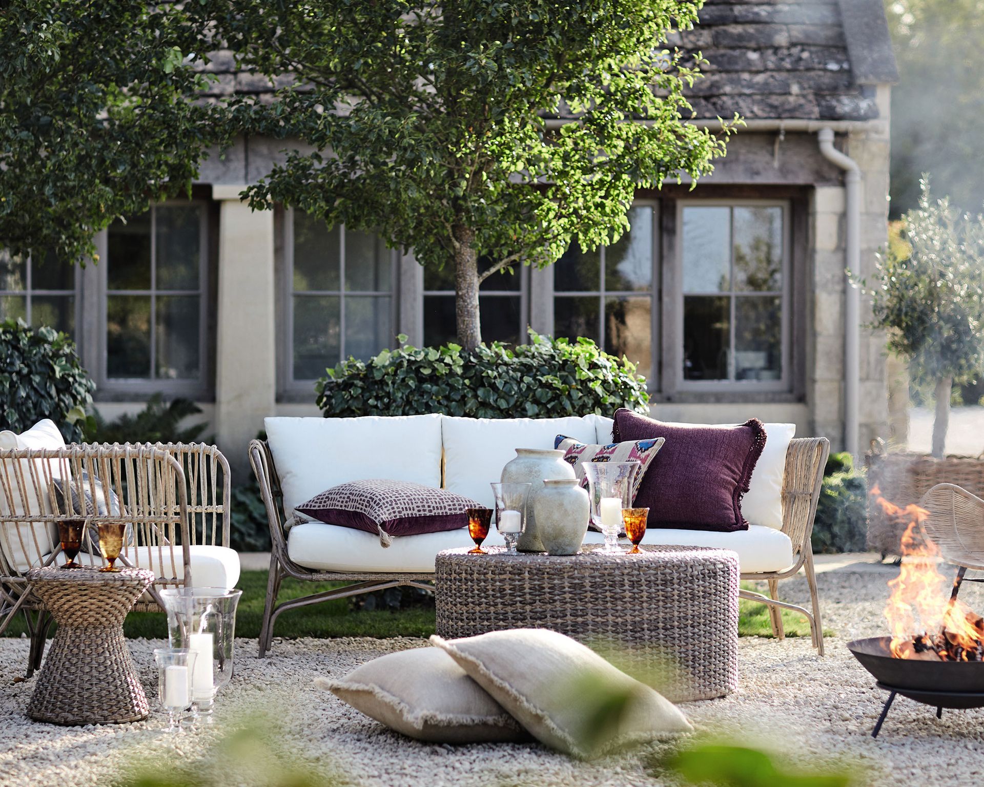 Garden seating in a traditional looking garden with a period house behind