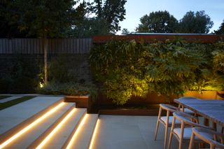 a living wall with outdoor lighting