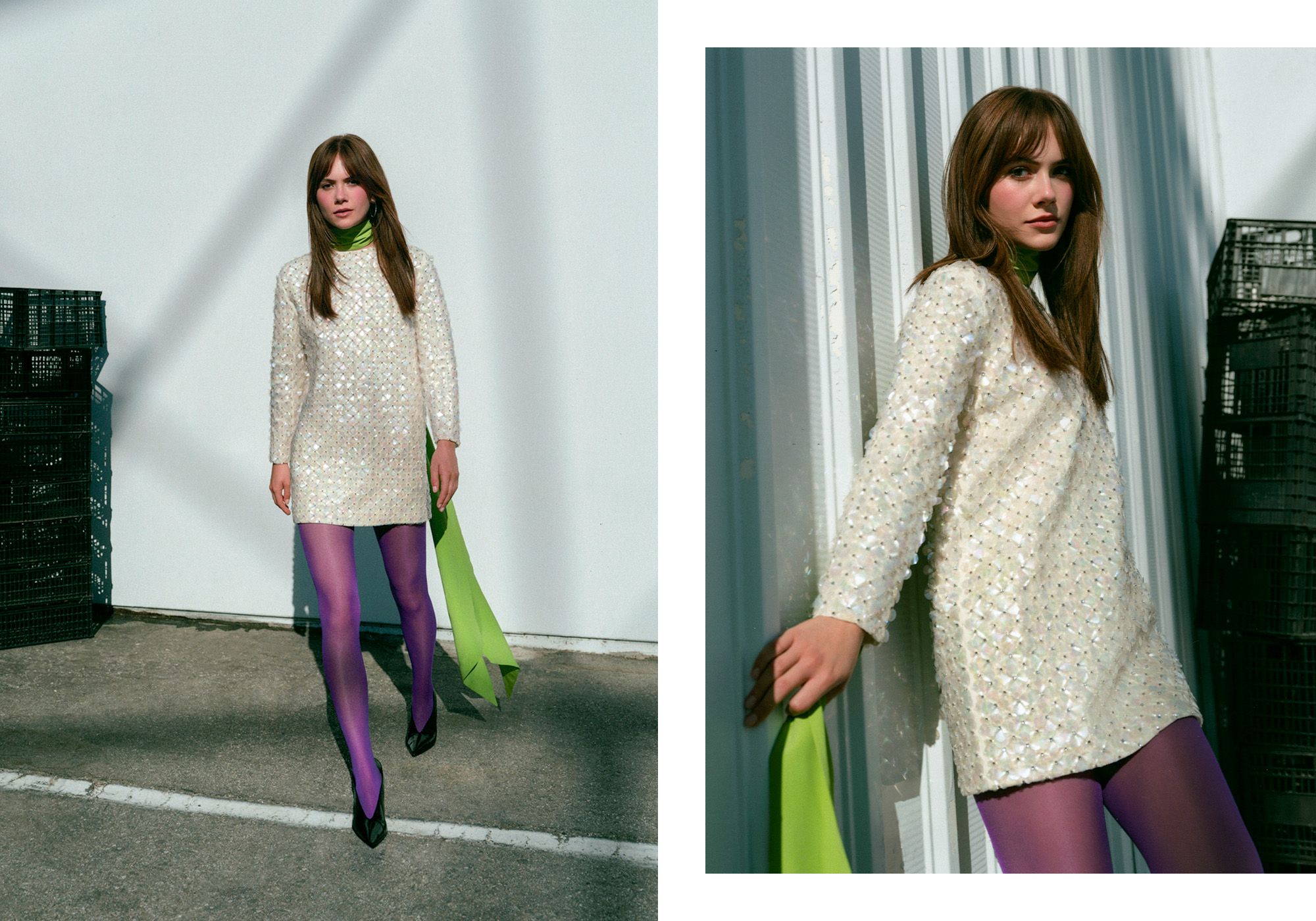Emilia Jones for WWW's fall Ones to Watch portfolio. She is standing outside next to a stack of black crates wearing a white beaded minidress with a green neck scarf and purple tights.