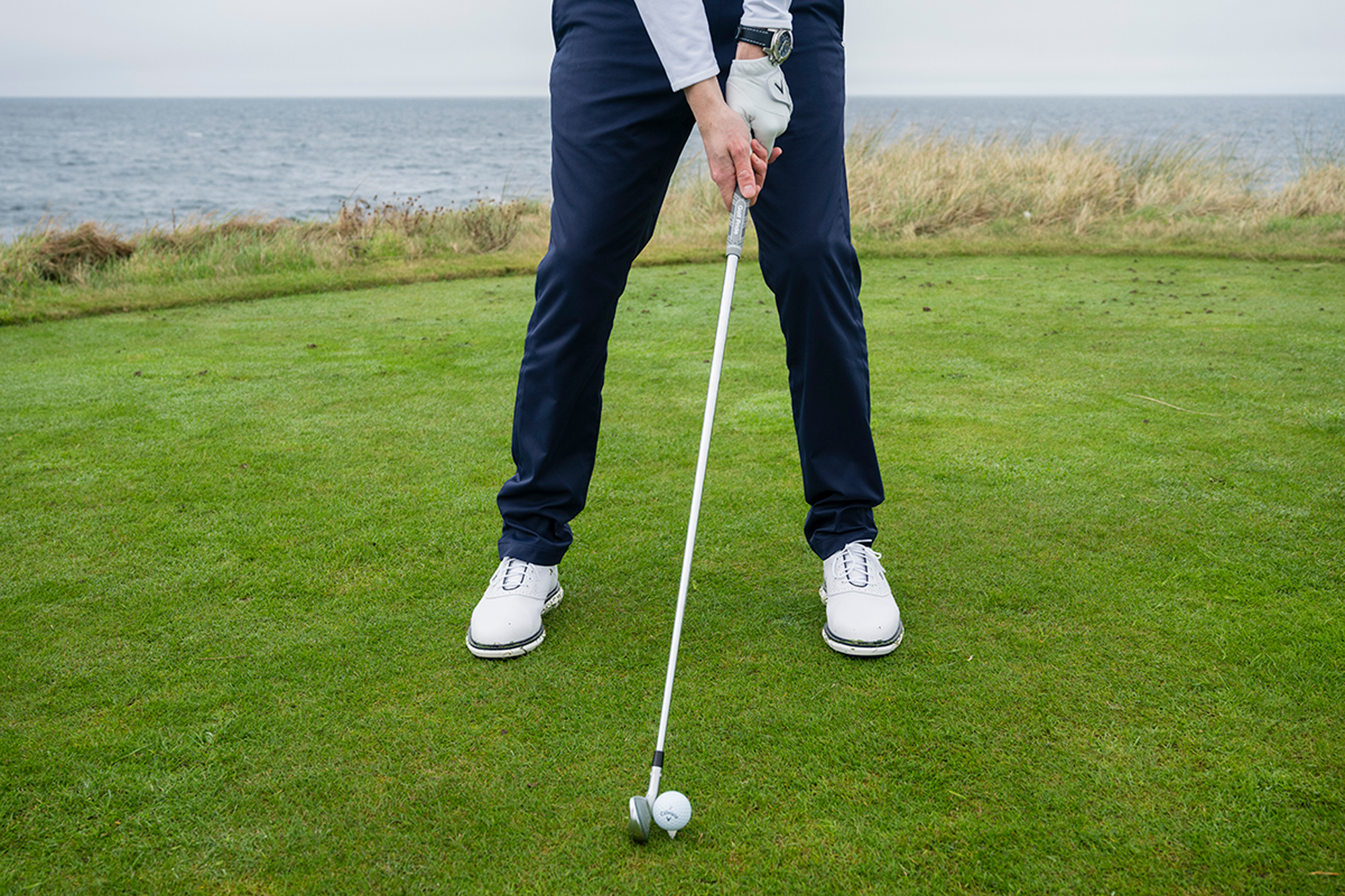Ben Emerson demonstrating how to change your setup in windy conditions, moving the ball back in your stance and putting the hands slightly forward to create shaft lean
