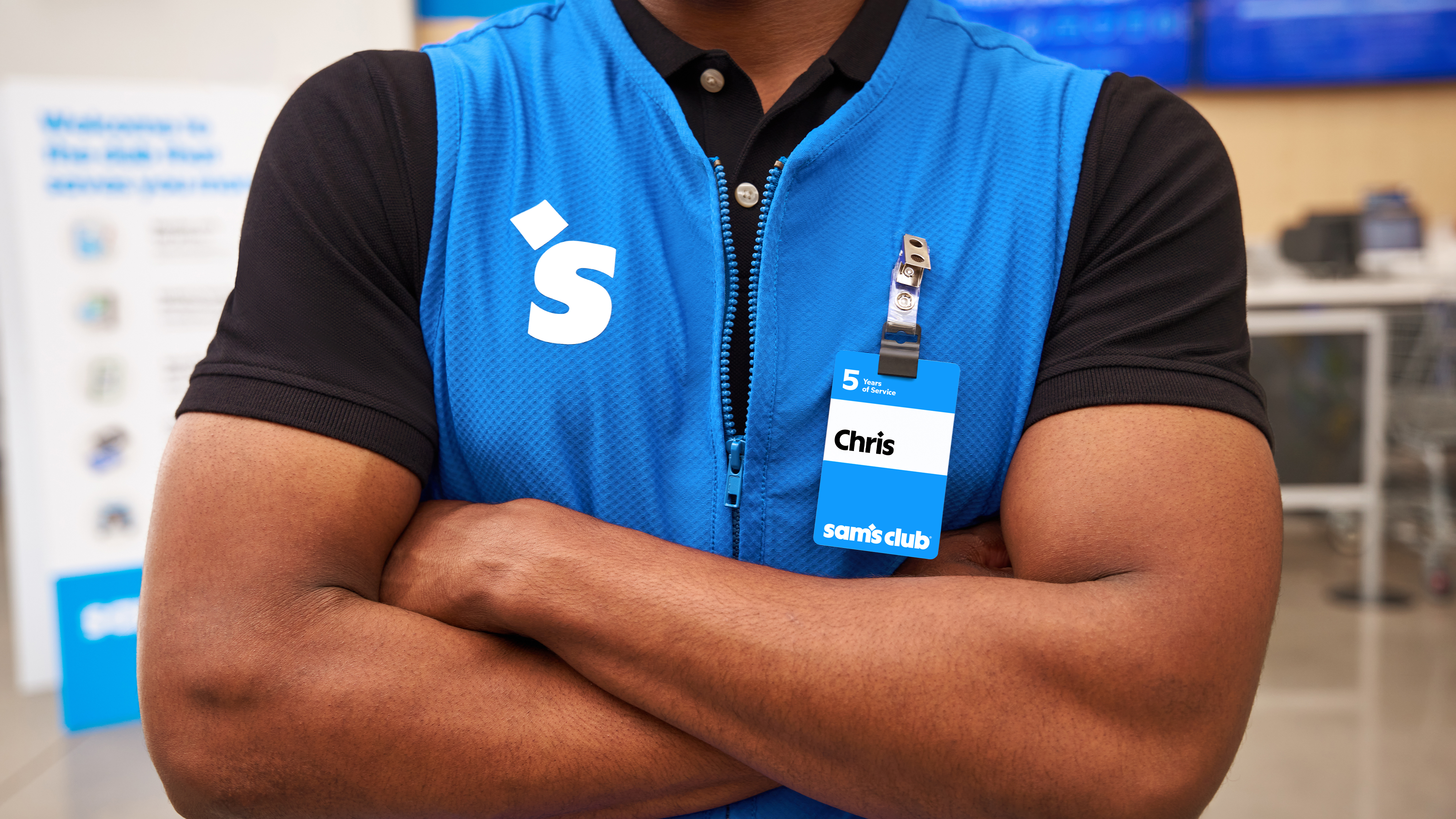 Sam's Club Associate with Crossed Arms