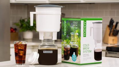 Toddy Cold Brew on a kitchen countertop with an iced brew and the box