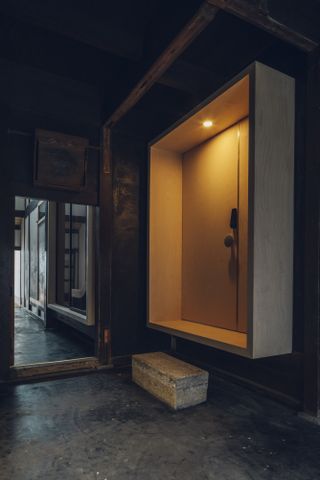Dark wood entrance at the Suzu apartment building renovation