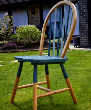 wood chair upcycled as an outdoor chair on the grass in a garden - jeyes fluid