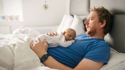 Father with infant asleep on chest