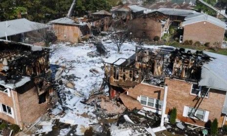 Firefighting foam covers the scene of a crash of an F/A-18D Hornet in Virginia Beach, Va.