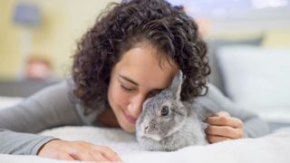 Woman petting grey bunny