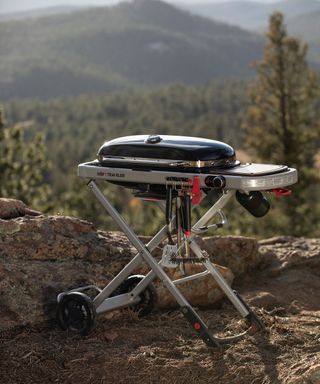 portable Weber Traveler BBQ outdoors in the countryside
