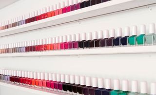 There are many colors nail polishes are arranged in the shelf