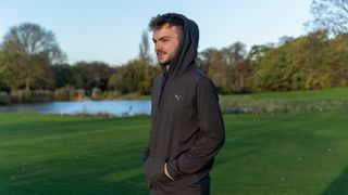 Dan Parker wearing the Puma Progress golf hoodie on a golf course