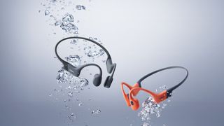 Shokz OpenSwim Pro - one in grey, one in red - in an underwater press pic