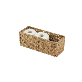 A natural woven bathroom organizer with toilet paper in it