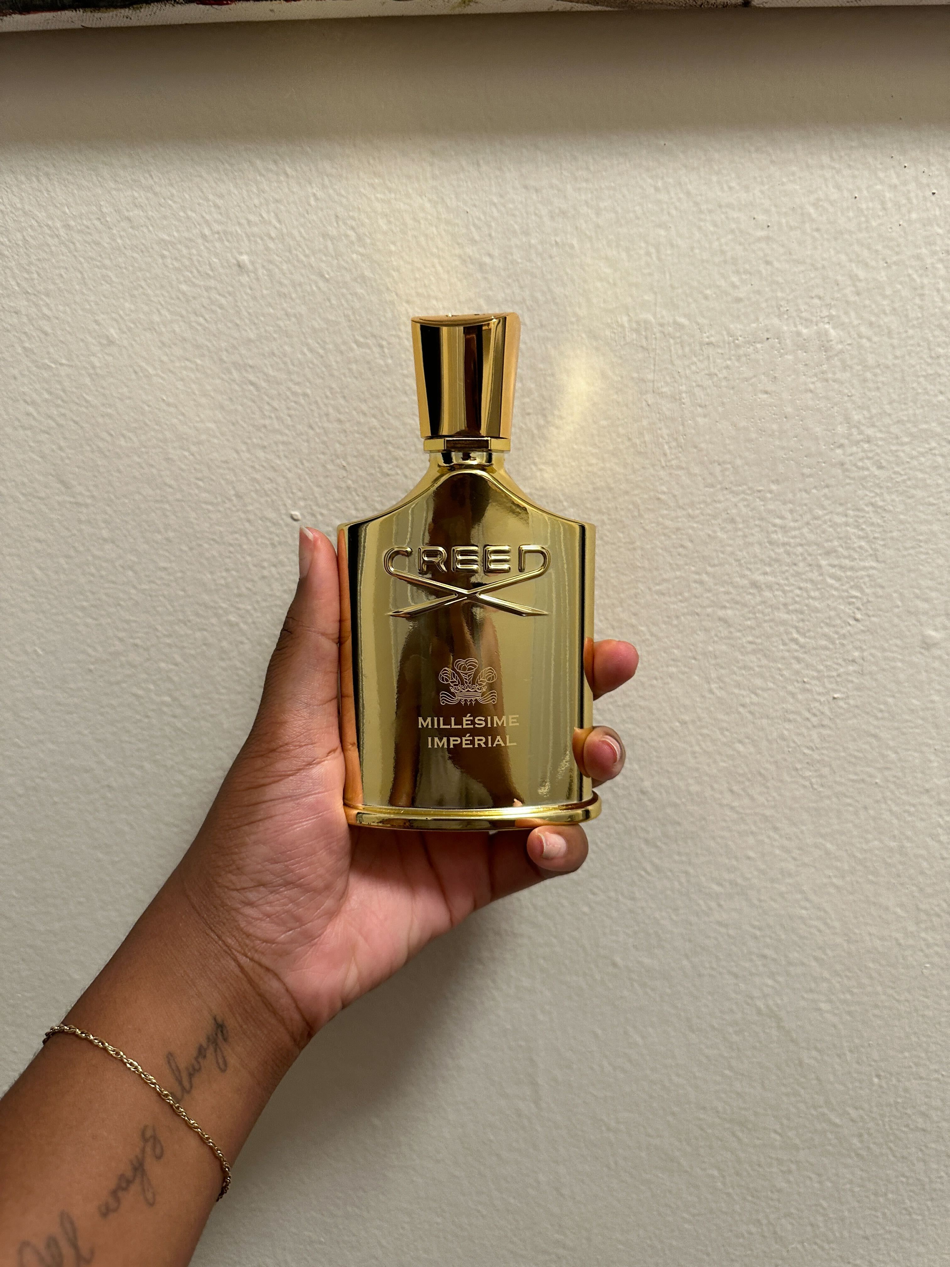 Ariel Baker testing Creed perfume