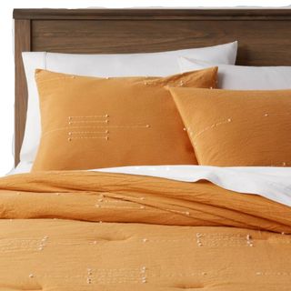 An orange bedding set with white lines