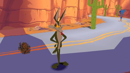 Screenshot of Sheep, Dog N' Wolf gameplay with Ralf Wolf standing on road next to tumbleweed and Road Runner in the backdrop.