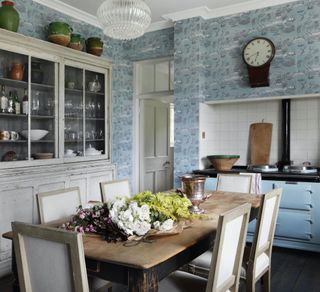 Light blue wallpaper and AGA, wooden dining table
