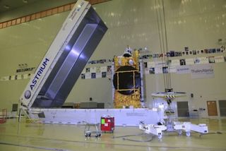 The Express AM4R spacecraft is removed from its shipping container to begin launch preparations at Baikonur.