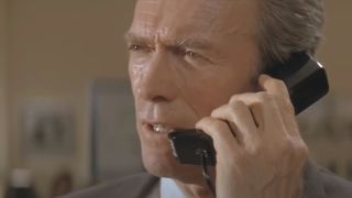 Clint Eastwood takes an intense phone call in In The Line Of Fire.