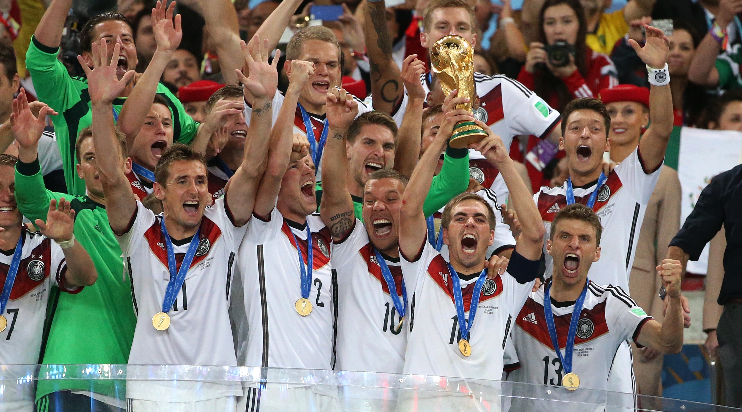 Philipp Lahm, captain of Germany holds the trophy and celebrate the victory with his teammates during the trophy presentation after the 2014 FIFA World Cup Brazil Final match between Germany and Argentina at Estadio Maracana on July 13, 2014 in Rio de Janeiro, Brazil.