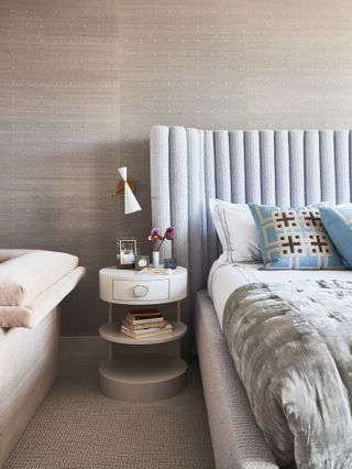 Light grey bedroom with blue headboard