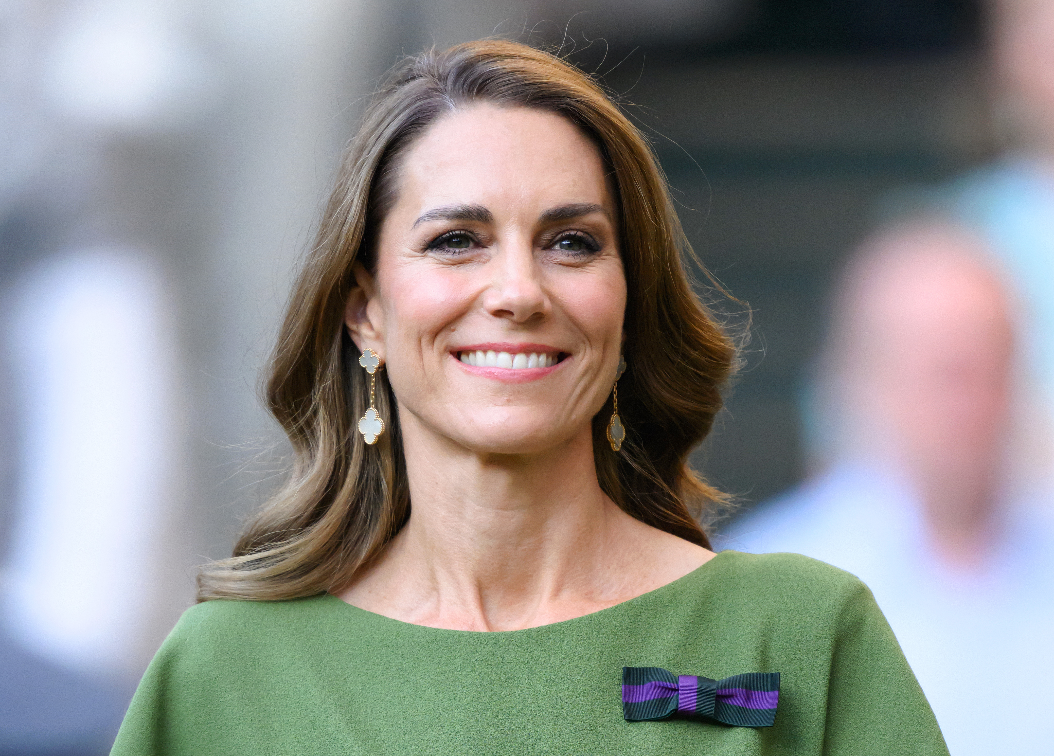 Princess Kate wearing a green dress and Van Cleef drop earrings