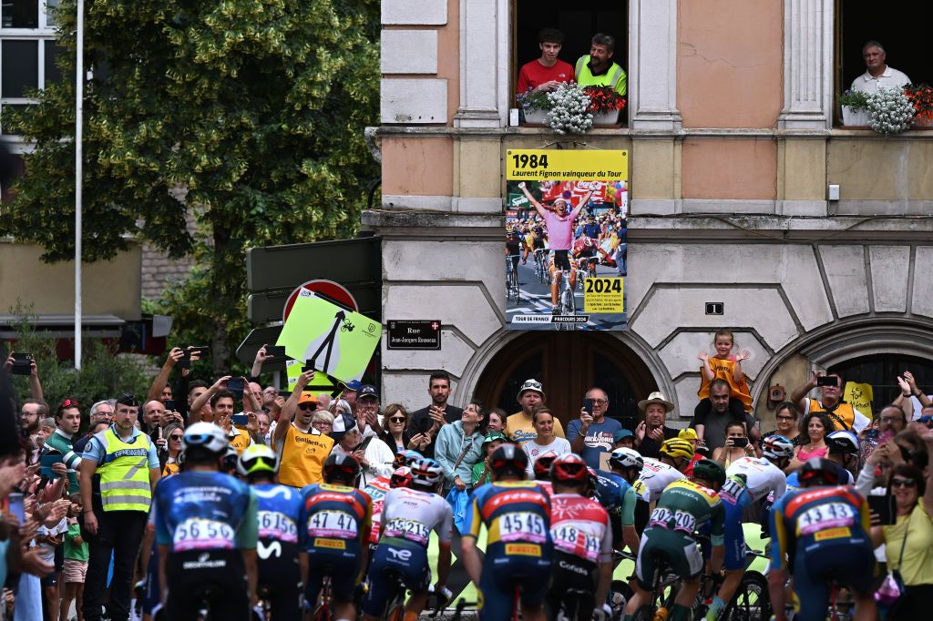 SAINT VULBAS FRANCE JULY 03 Fans cheer the peloton with a banner on which you can see the rider Laurent Fignon of France 1983 and 1984 winner of Tour de France during the 111th Tour de France 2024 Stage 5 a 1774km stage from SaintJeandeMaurienne to Saint Vulbas UCIWT on July 03 2024 in Saint Vulbas France Photo by Tim de WaeleGetty Images