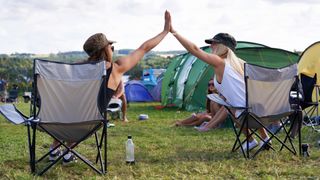 Happy campers high five at a festival